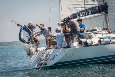 A group of people on a boat throwing a device in the sea. © Giuseppe Lupinacci