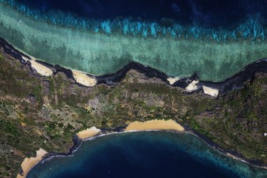 An aerial view of a land with a body of water. © Gabriel Barathieu / Ocean Image Bank.