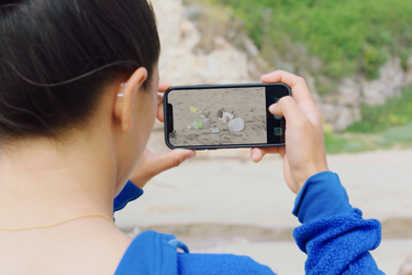 Picture of a woman taking a picture on a dune